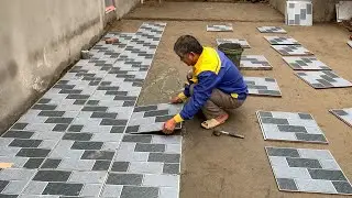 Installation Of 50x50cm Patterned Ceramic Tiles For The Outdoor Playground Of The House.