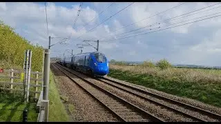 Striking blue Lumo 803 at speed and LNER Azuma 800 pass each other