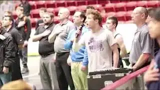 High school wrestler sings the National Anthem at match