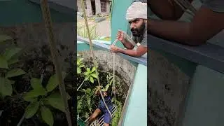 ഊഞ്ഞാലാടി കിണർ തേകി. | Cleaning the well.