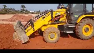 Jcb backhoe loader leveling school playing ground