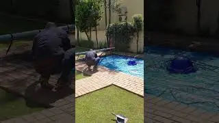 Placing Honeydew Nets LifeGuard safety net back on pool
