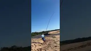 Jun Ismail hooking a Milk Shark fishing near a river mouth