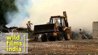 Firemen struggle to control fire at a garbage dump in Delhi