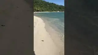 Walking along Matira Beach, the most famous public beach at the southern tip of Bora Bora Island.