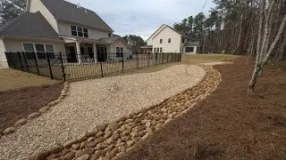 Live completion of Dry Creek bed installation and landscape drainage solution by Brooks Landscaping