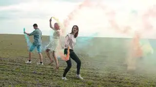Beautiful girl with friends with colored smoke bomb nice video