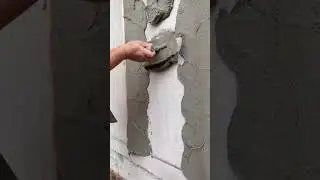 professional worker applying thick cement plaster on AAC block wall
