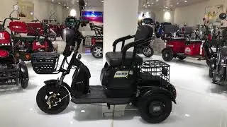 Electric tricycles with two adult seats and one children's seat.