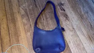 December 11 2021 purple vintage coach bag found at Goodwill on coat rack