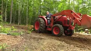 194 Using Box Blade to pull out remaining roots and small stumps or rocks at the camp build site