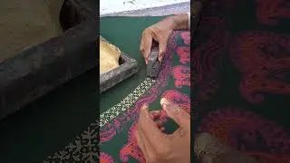 Joyful artisan showcasing creative craftsmanship through traditional block printing
