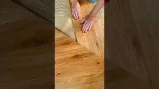 Manually installing tongue and groove wood flooring onto wet adhesive