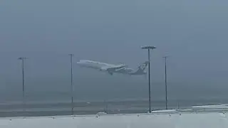 Air New Zealand Boeing 787-9 ZK-NZQ departing from Brisbane Airport in Ex Tropical Cyclone Alfred