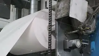 Industrial printing press processing large rolls of paper efficiently