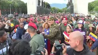 Supporters of President Nicol&aacute;s Maduro march in Venezuela amid tensions with the US