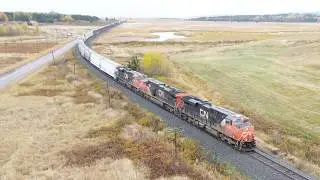 Awesome Aerial 4K View! Long Manifest Train CN 507 approaching Memramcook, NB at Track Speed