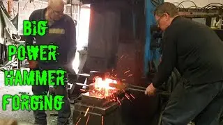Blacksmith forging an eye bolt with a big power hammer