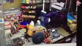 Video: Store owner fights off knife-wielding robber with baseball bat