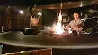 Grilling steaks over straw-fire in Warayakiya Roppongi