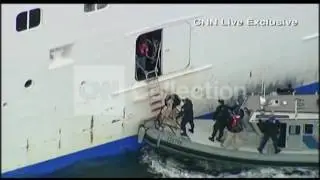 CRIPPLED CRUISE-OFFICIALS BOARD AT SIDE OF SHIP