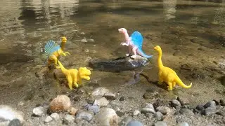 Looking for lots of small dinosaur toys on the river rocks