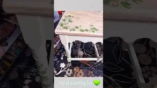 Hand painting Ivy onto a set of three furniture nest of tables