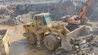 Powerful Caterpillar Loader Loading Giant Stones in Mountain Quarry