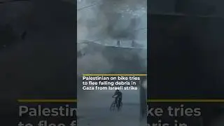 Palestinian on bike tries to flee falling debris in Gaza from Israeli strike | AJ #shorts