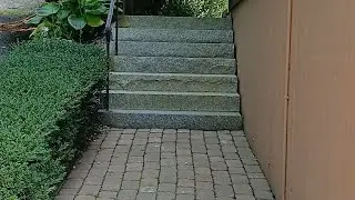 Pressure washing a brick paver walkway and granite stairs