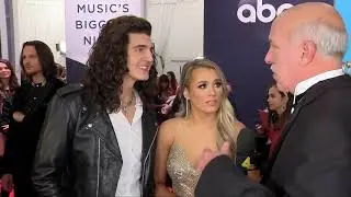 Cade Foehner and Gabby Barrett speak to Jimmy Carter on the CMA Awards Red Carpet
