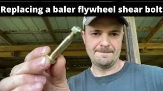 Replacing a flywheel shear bolt on a New Holland baler