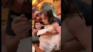 Father feeding daughter