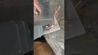 Technician marking aluminum sheet metal using laser level guide accurately