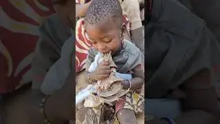 Wow!!A little girl in hadzabe tribe eating meat