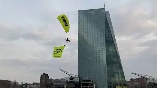 Greenpeace paragliders land on ECB building in protest