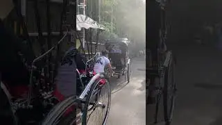Japanese man pulling rickshaw with tourists in Kyoto, Japan