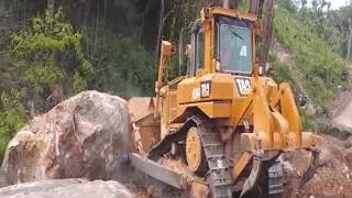 Cat D6T pushes big rocks tracks bulldozer pushing rocks rocks 2023