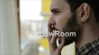 A man with a beard and mustache smoking