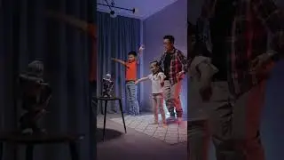 Children and Dad dancing along with robot 4K