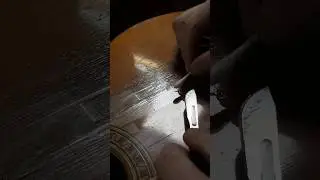 Removing scotch tape from a 1973 Robert Ruck classical guitar