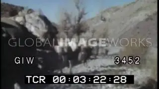 Afghan Guerrilla Looks Over a Mountain Holding AK-47 - 1988
