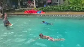 Kori is swimming against his classmates.