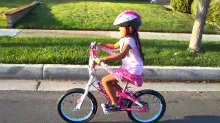 Adrienne Morrow rides her bicycle without training wheels or help!