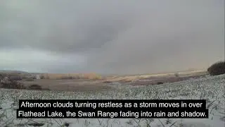 An afternoon storm building fast over Flathead Lake, clouds stacking up against the Swan Range.