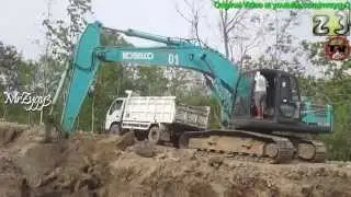 Excavator Kobelco SK200 Working Loading Dump Truck at Road Work