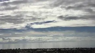 Melvaig Beach as a boat sails silently past