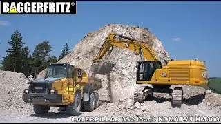 Caterpillar 352 excavator loads Komatsu HM300 truck