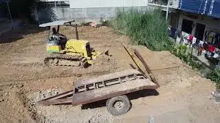 Bulldozer push the ground clearing the garbage with the skill of creating