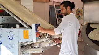 Baking traditional Taftoon bread,with a young baker
